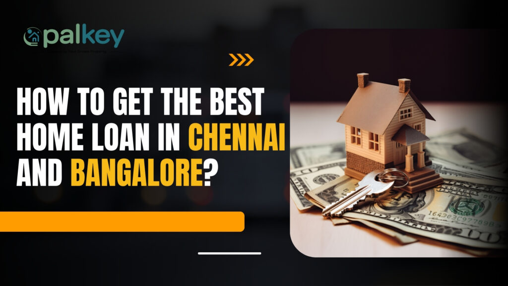 A miniature wooden house and a silver key placed on a stack of US dollar bills, symbolizing property investment and finance. The text asks: "HOW TO GET THE BEST HOME LOAN IN CHENNAI AND BANGALORE?".