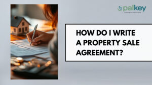 A promotional graphic for Opalkey with the text "HOW DO I WRITE A PROPERTY SALE AGREEMENT?". The left side features a close-up, warm-toned photograph of a hand holding a pen, poised to sign a legal document. A small model house sits nearby on a wooden desk, symbolizing the property transaction.
